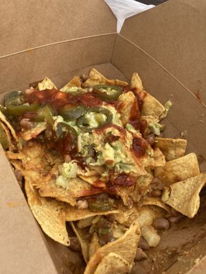 The bizness nachos hella size with vegan cheese and no crema (already 1/3 eaten)  at Nacho Bizness in Monterey