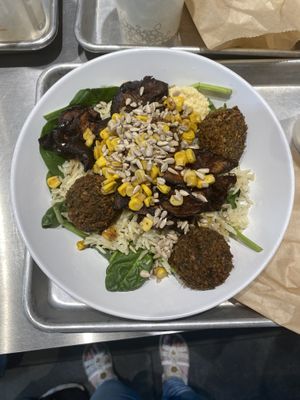 Build-your-own salad bowl. This bowl includes: spinach, rice, roasted eggplant and corn, fried falafel, and hummus  at Mezeh in Chesapeake City