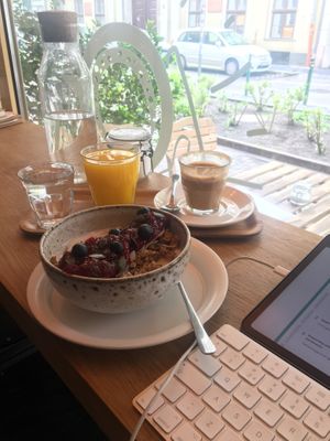 coconut yoghurt bowl, flat white (that i took some sips from already, so good) and fresh (but bottled) orange juice  at Fanka Budapest in Budapest