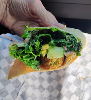 Falafel wrap (well, half of it) ☺️ at Black & White Cafe and Bakery in St Peters Bay