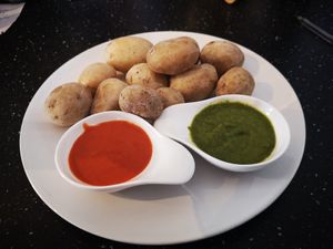 Papas arrugadas con mojo verde y mojo rojo at Madrid-Berlin Bistro in Fisterra