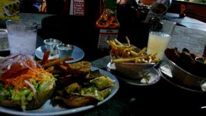 Oklahoma bacon cheeseburger, fries, and wings at Native Foods in Costa Mesa