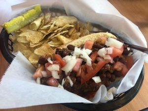 Vegan chili dog with tomatoes & onions added. at Un Mundo Café in Springfield