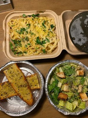 Fettuccine Alfredo, garlic bread and caesar salad at Fair Game in Austin