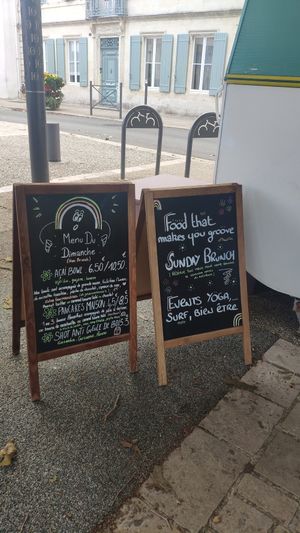 Signs in front with menu at Le Rainbowl in Saint-pierre-doleron