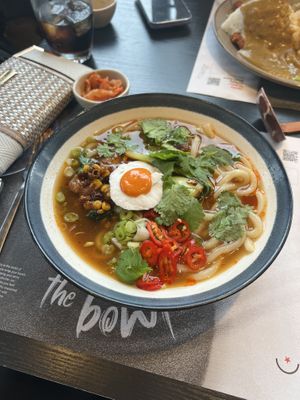 Spicy teriyaki chicken ramen with a vegan egg and side of kimchi   at Wagamama in Stoke-on-trent