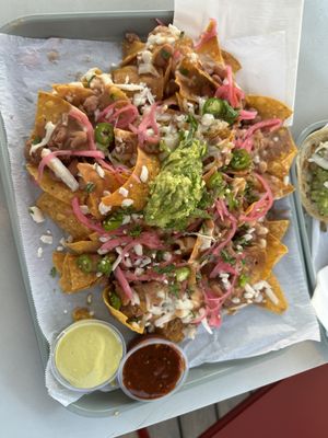 Nachos made vegan😄green creamy salsa and cheese both vegan   at Fonda Moderna in Tustin