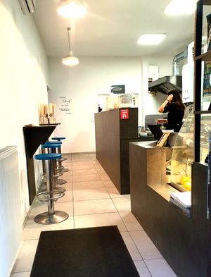 Front counter with bar chairs sitting. at BEMBA rawfood & plant-based in Bratislava
