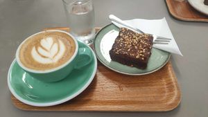 Cappuccino with oat milk and vegan brownie at Wiener Rösthaus im Prater in Vienna