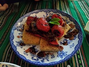 Chickpeas omelette (farinata) with confit tomatoes and basil at Green Life Market in Sarande