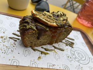 Pistachio mandarin vegan cake   at Pawdy Neighbors  in Dubai