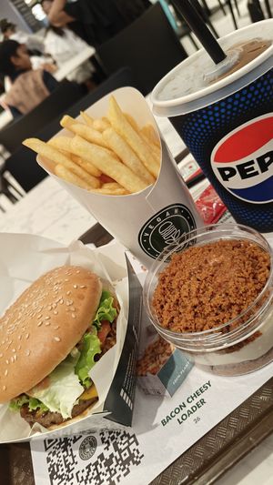 Smoked bacon burger meal and Lotus cheesecake at Vegan Burger - Dubai Mall in Dubai