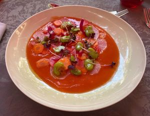 Starter: Soupe glacée de tomate, légumes croquants, févettes et olives Kalamata

Iced tomato soup with crunchy vegetables, fava beans and olives.
 at Le Parvis in Saintes