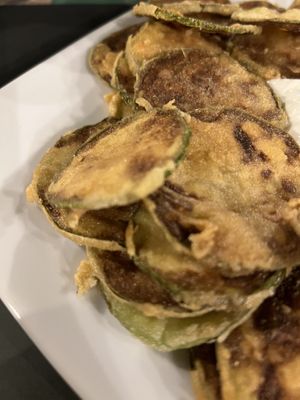 Fried courgette, bit burnt and came with yoghurt 🤦‍♀️  at Under The Pine Tree in Skiathos