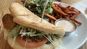 Tempeh sandwich with 1/2 salad +1/2 sweet potato fries  at Pure Kitchen - Rideau St in Ottawa