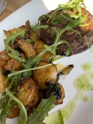 Vegan bean patty with roasted potatoes and vegetables and arugula.  at Bistro Marco in Zgornja Kungota