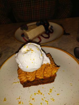 Carrot cake and cheesecake in the background at Bistro Verde in Copenhagen
