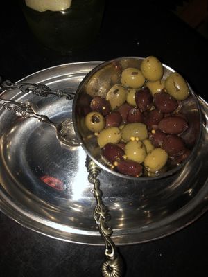 Olives with truffle oil, orange zest and mustard seeds   at MIRZAM COCKTAIL BAR in Gdansk