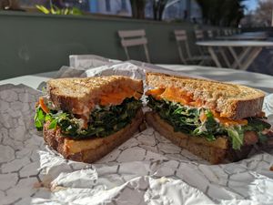 Autumnal sandwich with tempeh bbq bacon, kale, roasted sweet potato, aioli on sourdough at Clementine Bakery in Brooklyn