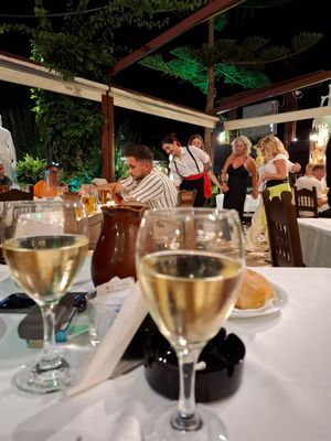 Carafe wine and dancing people at Taverna Vergina in Crete