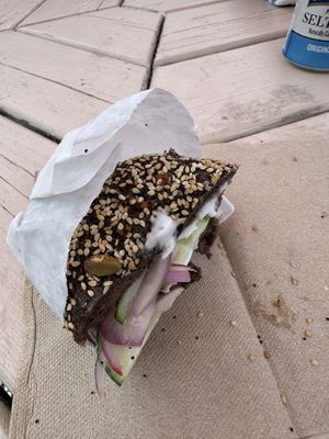 Pumpernickel everything bagel w vegan cream cheese, cucumbers, and red onion. (Sorry the photo quality is trash)  at Bagel Hound in Wellfleet