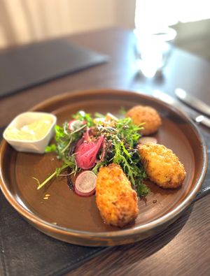 Crispy Cauliflower & Vegan Cheese Wings, Roasted Garlic Mayonnaise, Organic Leaves  at Poacher Restaurant in Ballina