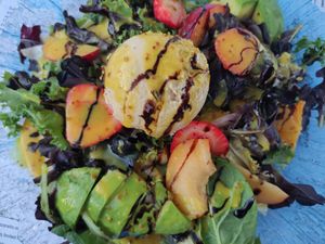 Salad with fruit, cheese replaced with hummus at Massai Mara Beach Club in Torre Del Mar