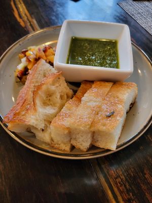 Foccacia, salsa verde, and pickled veggies at ['plas] in Columbus