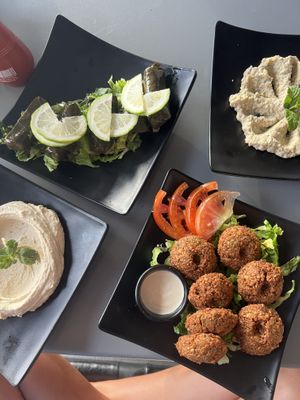 The most amazing vegan options i found in agadir , morocco! top left dolma (rice wrapped vines leaves), top right baba ghanoush, bottom left hummus and middle falafel.   at Zahrat Loubnan in Agadir