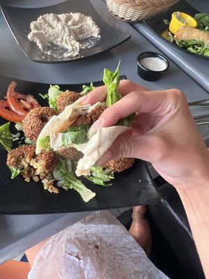 I asked for flatbread and created my own falafel wrap , it was delicious and so inexpensive! the white sauce pot is a wheat sauce fully vegan.  at Zahrat Loubnan in Agadir