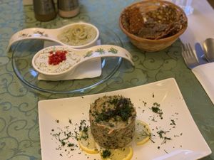 Mushroom terrine, pesto and feta almond cheese appetiser with raw bread  at Barca in Bucharest