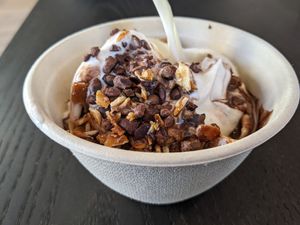 Vanilla oat milk soft serve with chocolate sauce and almonds at Rad Radish in San Francisco