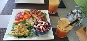 Beans on toast, curry soya meat, beetroot houmous, salads, fresh mix fruit juice at La Rotonda in Tirano