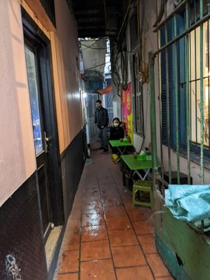 Alleyway with some tables and seating at Quán Phở Chay anh Hải in Hanoi