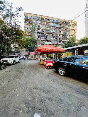 Outside. I entered on Pavstos Buzand St, small alley with a car park barrier. Pass through here and it will open up to this parking lot. The cafe is the last unit on the right.   at 2022_place - Pop Up in Yerevan