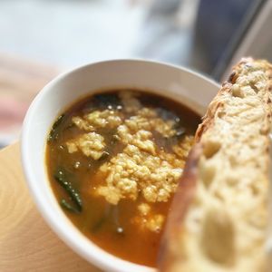 "Cheese" soup with white beans, spinach, beet tops, tomatoes with homemade vegan cheese and homemade focaccia  at 2022_place - Pop Up in Yerevan