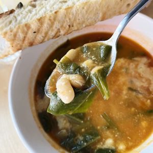 "Cheese" soup with white beans, spinach, beet tops, tomatoes with homemade vegan cheese and homemade focaccia  at 2022_place - Pop Up in Yerevan