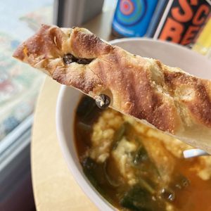 The fresh and crispy homemade focaccia with oregano for "cheese" soup at 2022_place - Pop Up in Yerevan