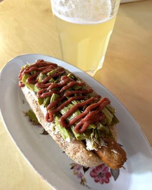 Limited-time special hot-dog, including homemade chikun sausage (tofu+seitan), baked asparagus, grilled lemon-thyme sauce and topped with strawberry ketchup at 2022_place - Pop Up in Yerevan