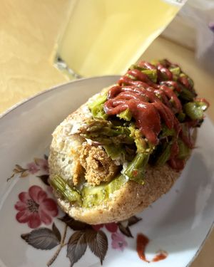 Limited-time special hot-dog, including homemade chikun sausage (tofu+seitan), baked asparagus, grilled lemon-thyme sauce and topped with strawberry ketchup at 2022_place - Pop Up in Yerevan