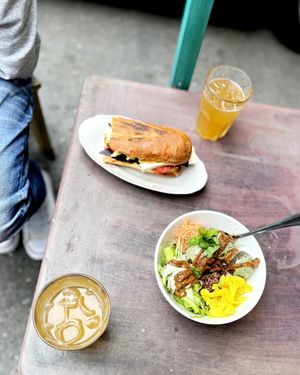 Our super hearty and delicious lunch outside: sandwich with fried crispy eggplant and tofu, falafel bowl and Lager Citrus lemonade at 2022_place - Pop Up in Yerevan