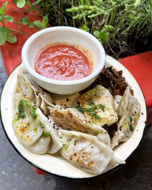 Vegan special gyoza with oyster mushrooms, champignons, tofu cream cheese, tomato sauce and mandak-kimchi amuse-bouche on the side. at 2022_place - Pop Up in Yerevan