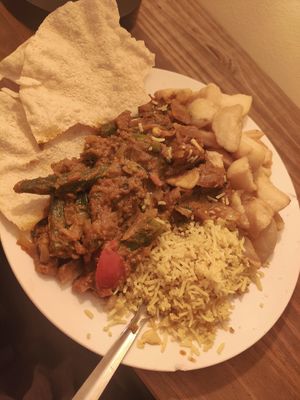 vegan garlic chilli veg curry with garlic pilau rice, a side of bhindi bhaji, chips and poppadoms at Spice Station in South Shields