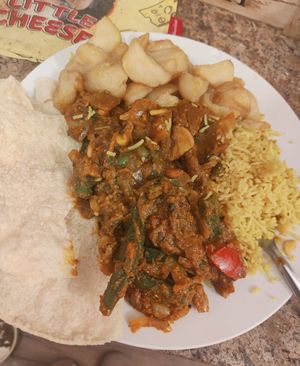 vegan garlic chilli veg curry with garlic pilau rice, a side of bhindi bhaji, chips and poppadoms at Spice Station in South Shields