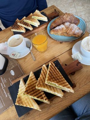Avo on toast (Italian way), vegan croissants with fruit jam, soy cappuccinos, and fresh orange juicee  at Caffe Cactus in Golfo Aranci