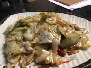 Shredded cabbage stir-fried to perfection, this dish features a smoky aroma and a delightful crunch. Tossed with chili and garlic, it’s a simple yet flavorful homestyle classic.  at Kungfu Kitchen in Reading