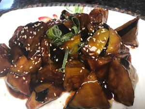 Braised aubergines are a rich and savory delight! Soft, tender eggplants are simmered in a flavorful soy-based sauce, infused with garlic and chili, creating a melt-in-your-mouth h at Kungfu Kitchen in Reading