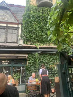 Typical German waitress and waiters  at Weingasthaus Breuer's Rüdesheimer Schloss in Ruedesheim Am Rhein