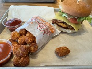 Chicken bacon ranch sandwich with tater tots  at Next Level Veggie Grill in Denver