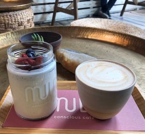 coconut yoghurt bowl and small soy cappuccino   at Mula in Tel Aviv